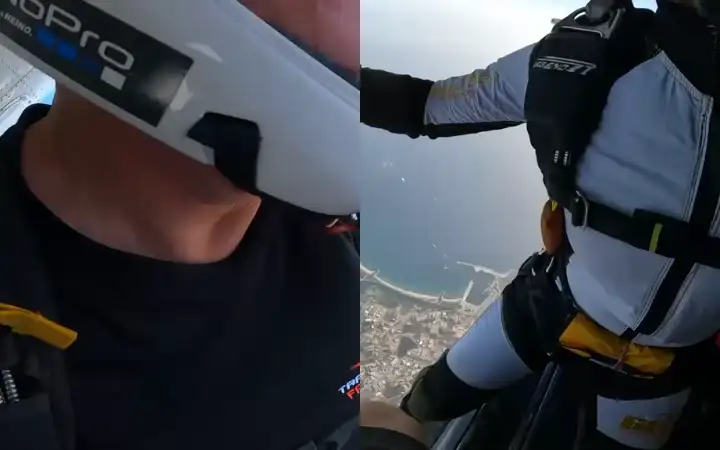 Springer im freien Fall über dem Meer, gefilmt mit der Kamera am Handgelenk